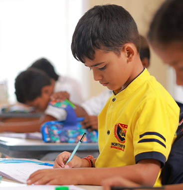 Student writing in a notebook