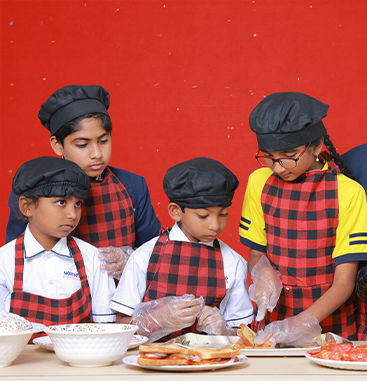 Students cooking together in chef hats